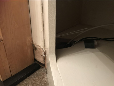 This is a portion of missing skirting to the left of the cabinet as you look at it. To the left of this area is a gas fire. On the picture I THINK you can see a gas pipe