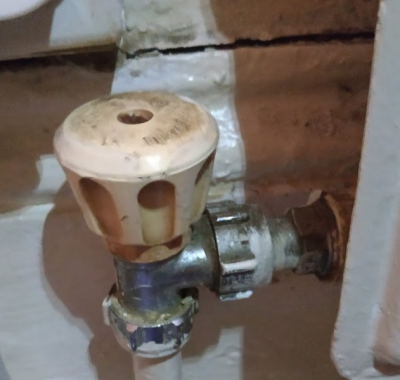 left hand valve (turned clockwise to off position). hard to get casing off because screw is damaged and there is a wall mounted plug directly above it