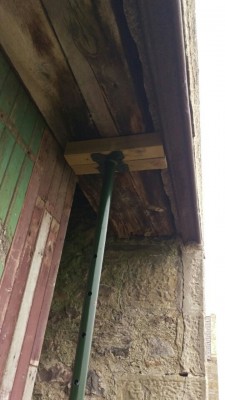 View of acrow jack supporting rotten ends of wooden lintel and stone lintel. You can see steel railway line inserted at some point for stability.