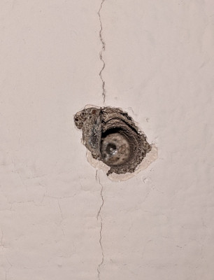 One of my drill holes into the bathroom ceiling/aggregate