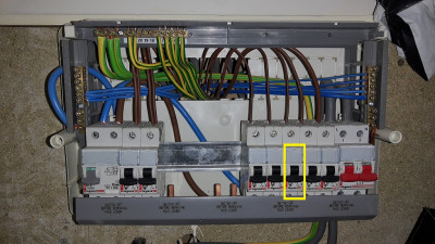 Opened fusebox with the smoke detector circuit breaker marked.