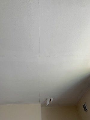 Photo of cracks and ceiling paint coming off