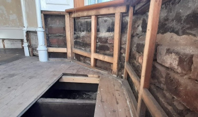 Some of the wood paneling has been removed. The plaster walls in the background are lath and plaster on studs.